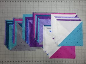 A close up of the folded squares on the quilt
