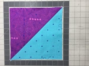 A purple and blue quilt with polka dots on it