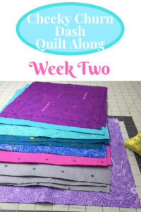 A pile of fabric next to a pair of scissors.