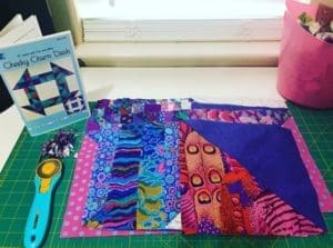 A book and some fabric sitting on top of a table.