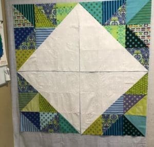 A quilt with a diamond pattern on it.