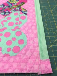 A close up of the corner of a quilt