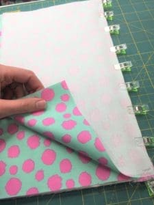 A person is sewing on the fabric