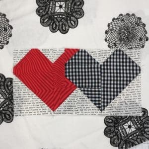 A close up of two hearts on a quilt