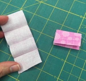 A person holding onto the paper that is folded