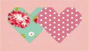 A heart shaped fabric with flowers and polka dots.