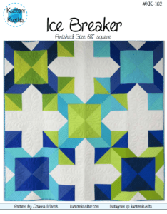 A quilt that is made of blue and green squares.