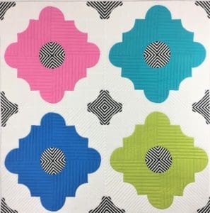 A colorful tile pattern with black and white dots.