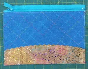 A close up of the back of a blue purse