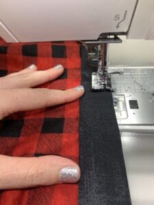A person using a sewing machine to make fabric.
