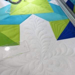 A quilt is being made with the help of a machine.