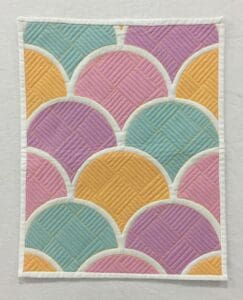 A close up of the colorful pattern on a quilt