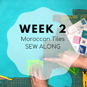 A person using a pair of scissors to cut fabric.