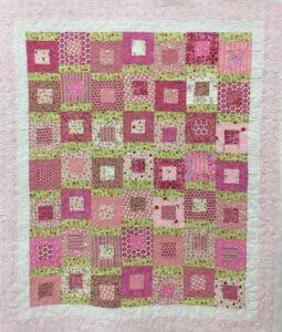 A quilt with squares of different colors and patterns.