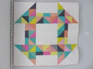 A quilt with different colored squares on it.