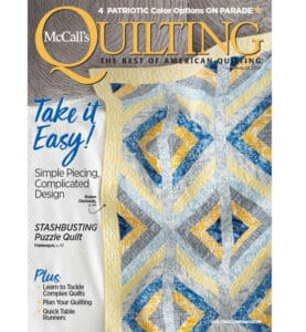 A magazine cover with a quilt on it.