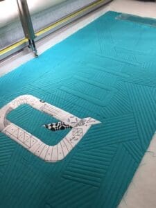 A person is laying on the floor in front of an entrance.