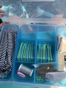 A plastic container with many different items in it.