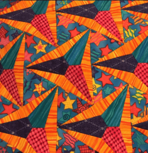 A colorful quilt with stars and other shapes.