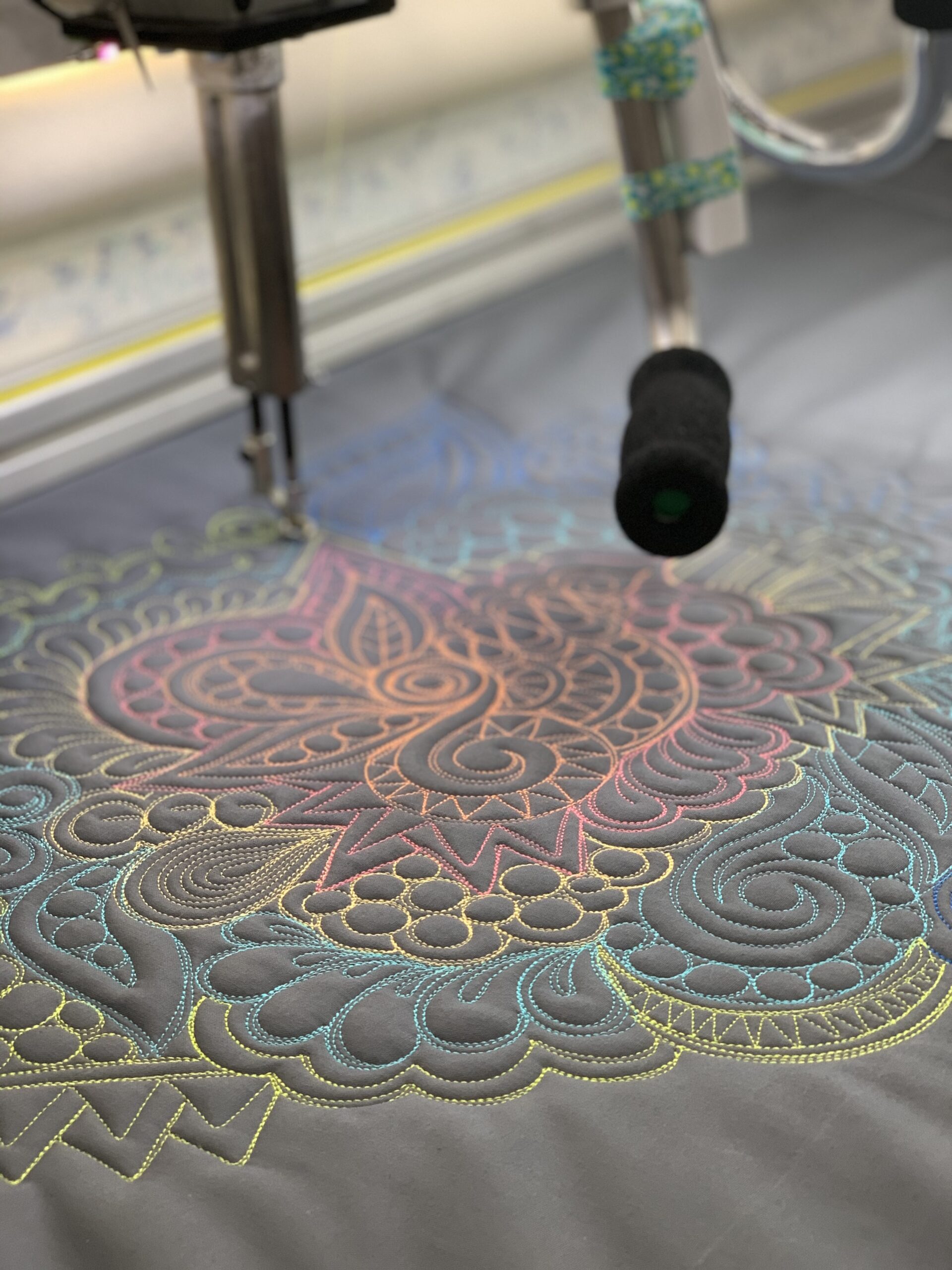 A machine is cutting out designs on fabric.