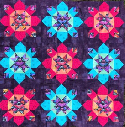 vibrant quilt with reds and bright blues