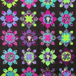 A quilt with different colored flowers on it.