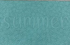 A close up of the word summer on a blue background