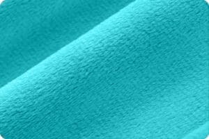 A close up of the fabric in turquoise