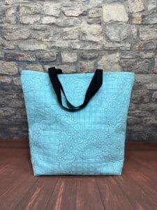 A blue bag sitting on top of the floor.