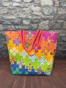 A colorful bag sitting on top of a wooden floor.