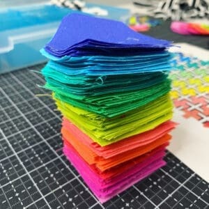 A stack of colored paper on top of a table.