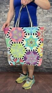 A person holding onto a colorful bag