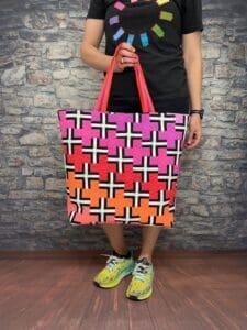A person holding onto a bag with crosses on it
