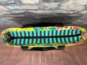 A surfboard sitting on top of a wooden floor.