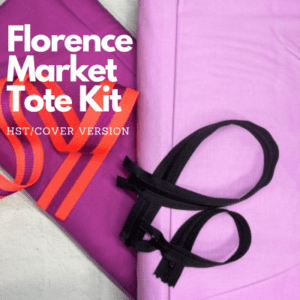 A purple bag and some black ribbons on top of it.