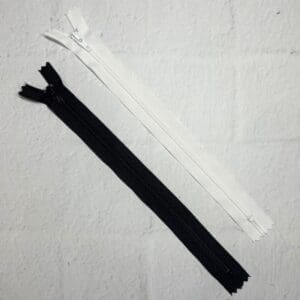 A pair of zippers are laying on the floor.