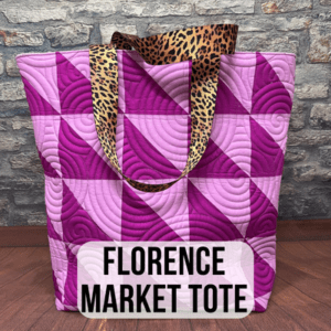 A purple and pink tote bag with leopard print handles.
