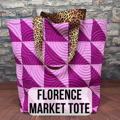 A purple and pink tote bag with leopard print handles.