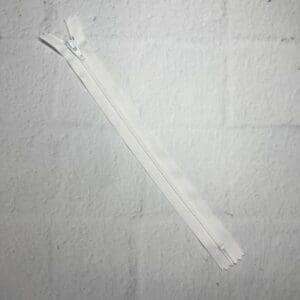 A white piece of fabric with two zippers.