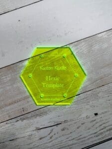 A hexagonal shaped glass coaster with the name of the person.