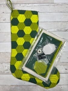 A green and yellow mat with a box of beads