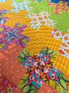 A close up of the colorful quilt