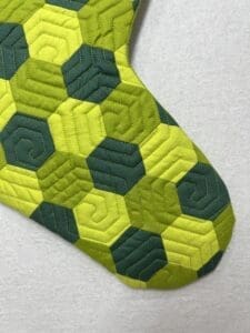 A close up of the green and yellow quilt
