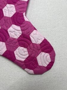 A close up of the quilted pattern on a christmas stocking
