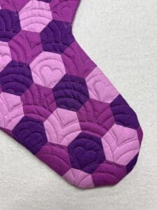 A purple quilt with hearts on it