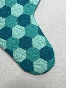 A close up of the quilted pattern on a christmas stocking
