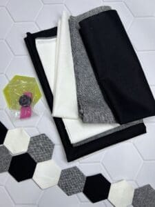 A table with some fabric and a hexagonal tile floor