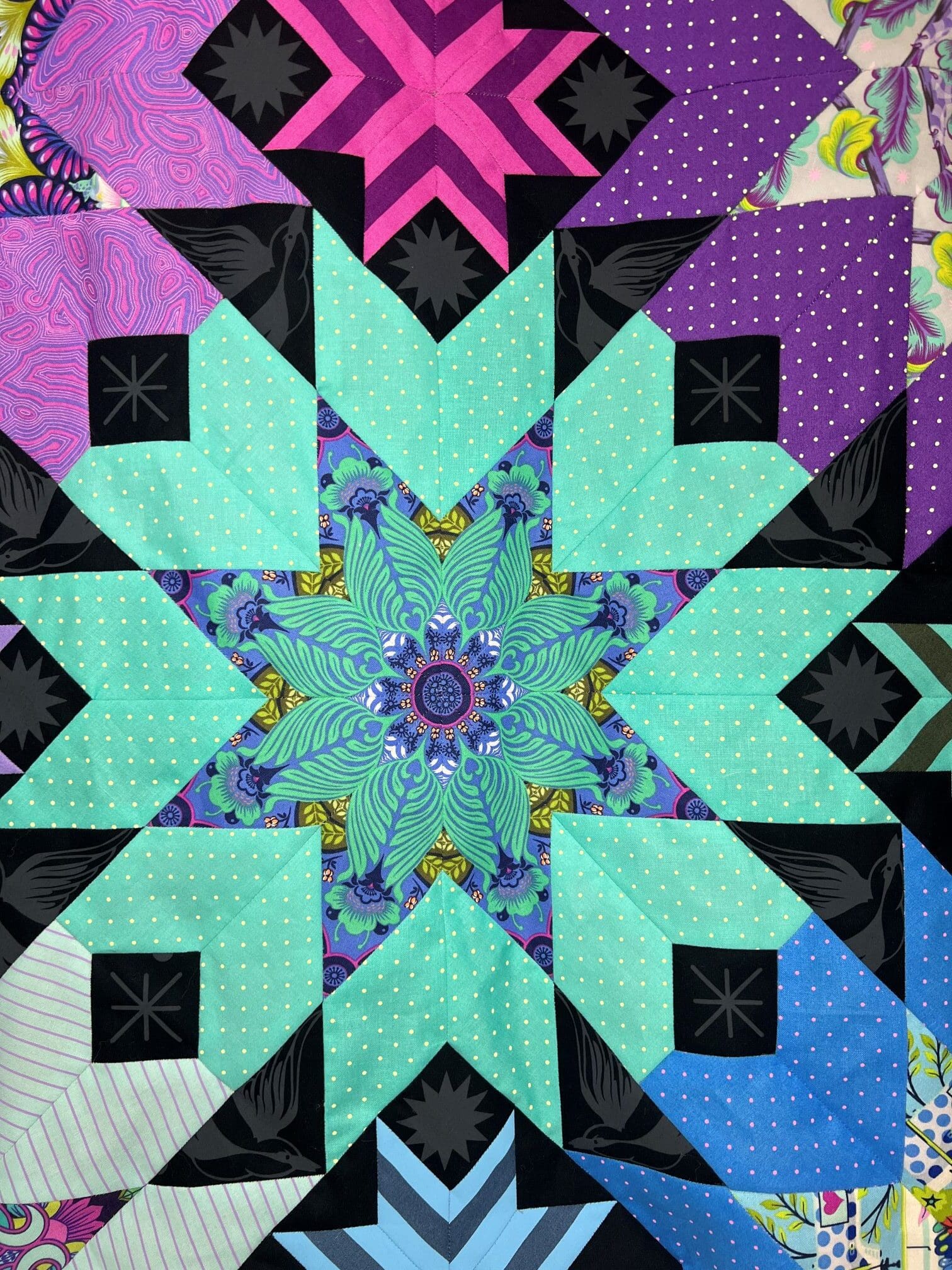 A quilt with a star design in the center.
