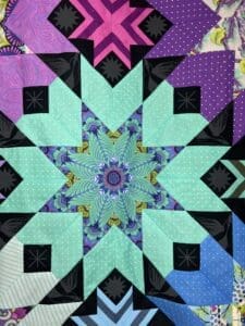 A quilt with a star design in the center.