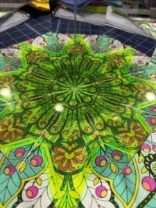 A green and yellow umbrella with a design on it.